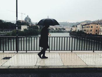 Full length of woman in city against sky