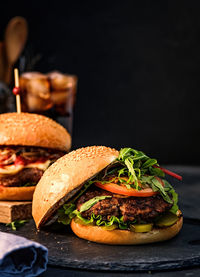 Close-up of burger against black background