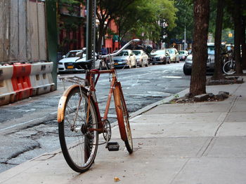 Bicycle parked on street in city