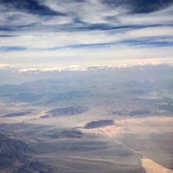 Aerial view of landscape against cloudy sky