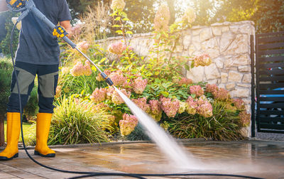 Low section of man standing by fountain
