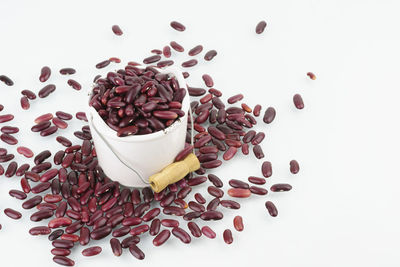 High angle view of coffee beans against white background