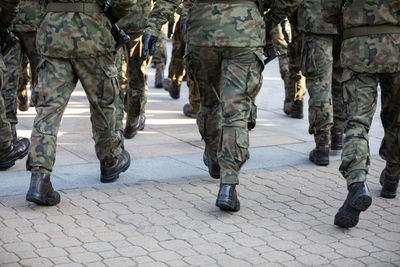 Rear view of marching soldiers in full uniform.