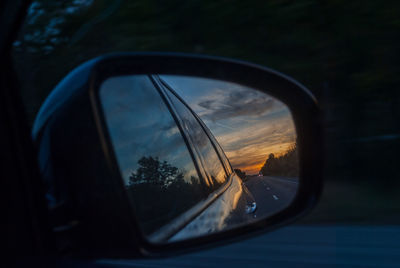 Reflection of car on side-view mirror
