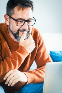 Young man using laptop at home