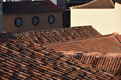 Close-up of  roofs of building and round windows