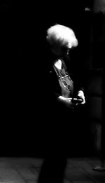 Rear view of woman standing at night