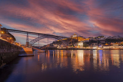 Dom luis i bridge by night in porto, portugal, douro river waterfront