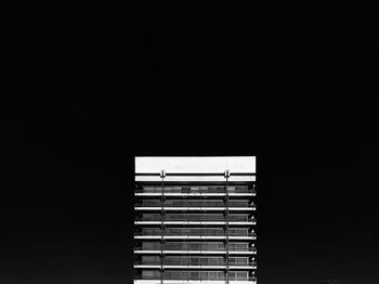 Low angle view of illuminated building against sky at night