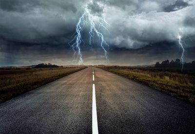 Lightning over road during sunset