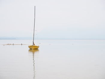 Sailboat in sea against clear sky