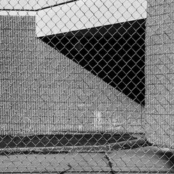 Close-up of chainlink fence against building
