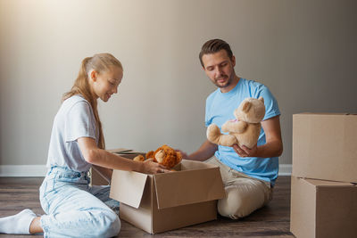 Side view of boy holding teddy bear