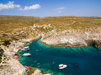 High angle view of sailboats on sea shore against sky