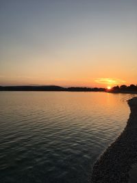 Scenic view of sea against clear sky during sunset