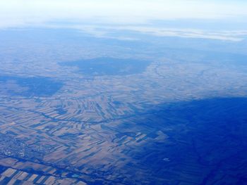 Aerial view of landscape against blue sky