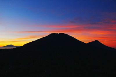 Scenic view of silhouette mountains against sky during sunset