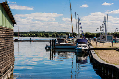 Boats moored at harbor