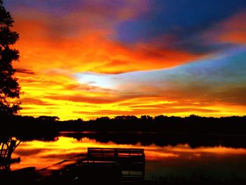 Scenic view of lake against orange sky