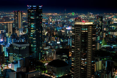 Aerial view of city lit up at night