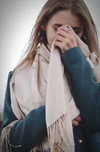 Close-up of woman covering face with shawl while standing outdoors