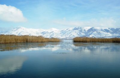 Scenic view of lake and mountains against sky