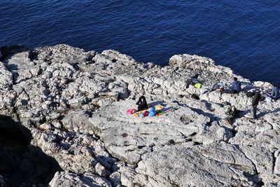 High angle view of people on rocks at beach