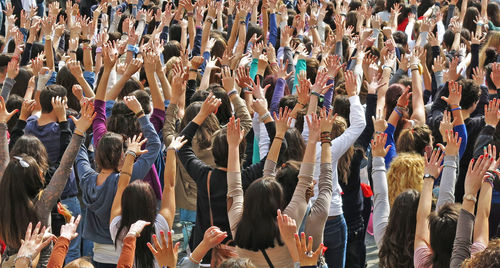 Arms raised people enjoying during event