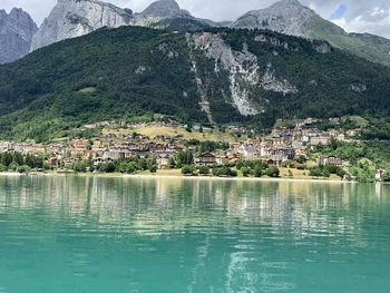 Scenic view of townscape by mountains