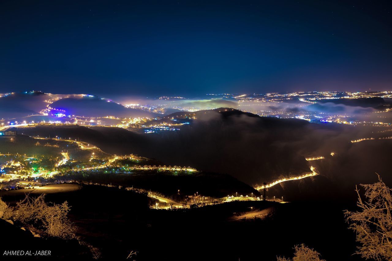 ILLUMINATED CITYSCAPE AT NIGHT