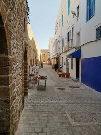 Street amidst buildings in town against sky