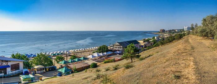 Panoramic view of the public beach in chernomorsk city on a sunny summer morning