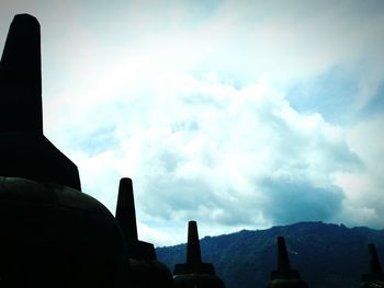 Low angle view of silhouette building against sky