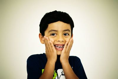 Portrait of happy boy against white background