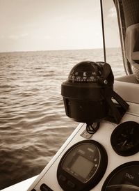 Close-up of coin-operated binoculars against sea