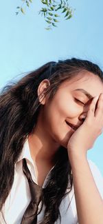 Close-up portrait of a beautiful young woman with eyes closed