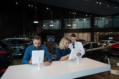 Portrait of female friends using laptop at airport