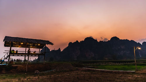 Scenic view of silhouette field against sky during sunset