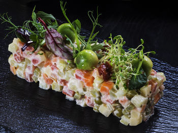 Close-up of olivier salad on slate