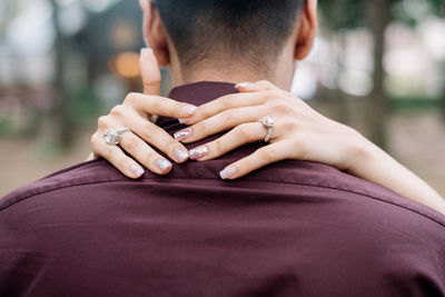 Close-up of woman embracing man while standing outdoors