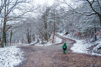 Full length of man standing on snow covered land