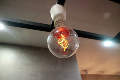 Low angle view of illuminated light bulb