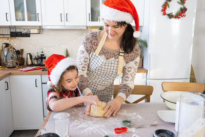 Portrait of smiling young woman preparing food at home