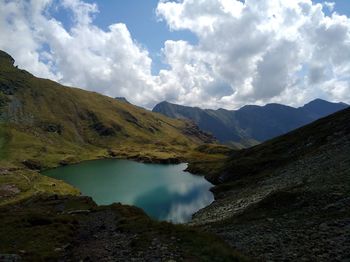 Scenic view of lake and mountains against sky