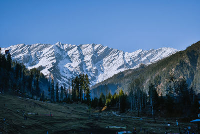 Scenic view of snowcapped mountains against clear sky