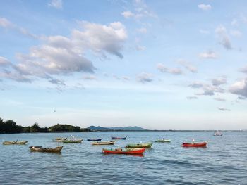 Boats moored on sea against sky