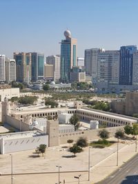 Buildings in city against clear sky