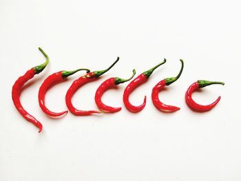 High angle view of chili peppers on white background