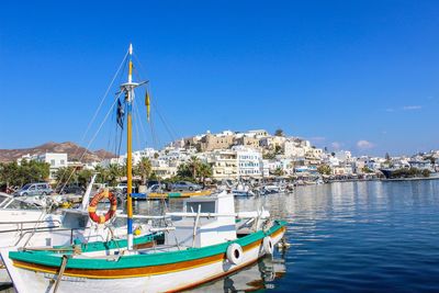 Sailboats moored in harbor