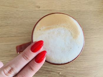 Close-up of hand holding red drink